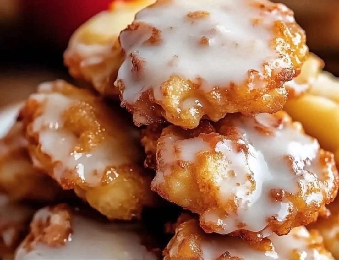 Delicious baked apple fritters dusted with cinnamon sugar on a plate.