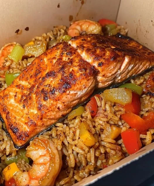 Cajun Salmon & Shrimp Dirty Rice Bowl Cajun salmon and shrimp served in a dirty rice bowl
