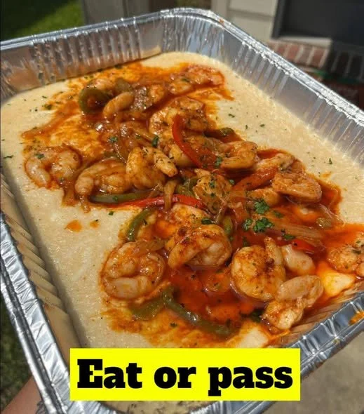 Cajun Shrimp and Grits Delicious Cajun shrimp and grits served in a bowl, garnished with herbs.