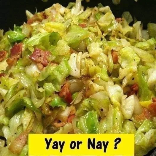 Fried Cabbage with Bacon, Onion, and Garlic Plate of fried cabbage with bacon, onion, and garlic garnish