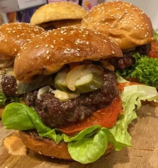 Homemade Beef Burger Juicy homemade beef burger topped with fresh vegetables and condiments
