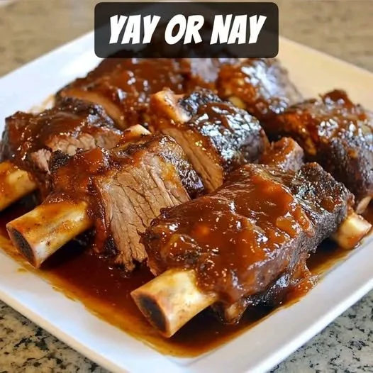 Slow Cooker Barbequed Beef Ribs Slow cooker barbequed beef ribs served on a plate.