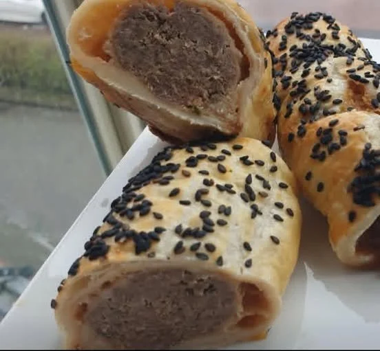 Spicy Meat Rolls in Puff Pastry Spicy meat rolls in puff pastry on a serving platter
