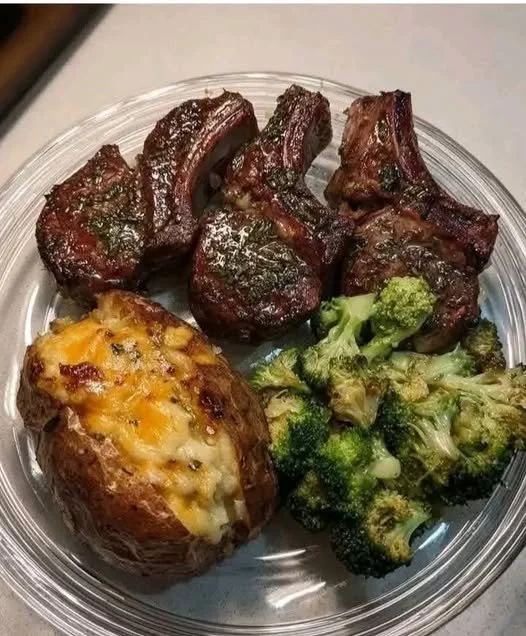 Juicy Lamb Chops with Loaded Baked Potato & Garlic Broccoli Juicy lamb chops with a loaded baked potato and garlic broccoli on a plate