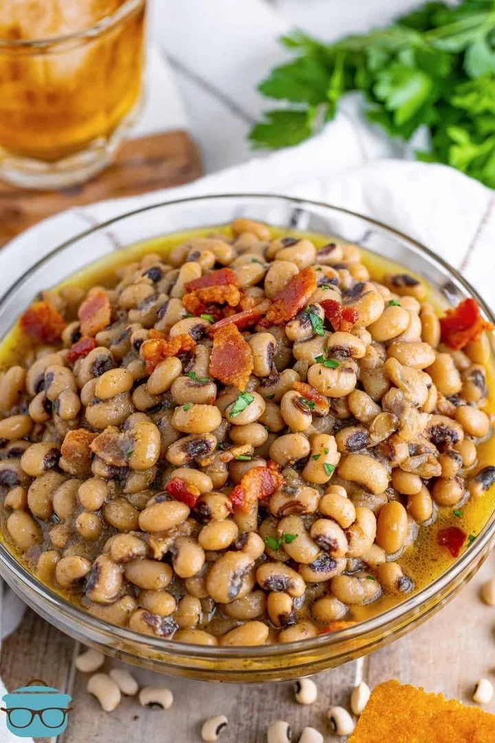Southern Black Eyed Peas A bowl of Southern Black Eyed Peas garnished with herbs.